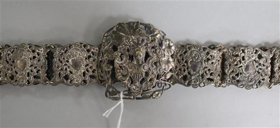 A silver plated nurses belt, decorated with mask and scrolls, 72cm